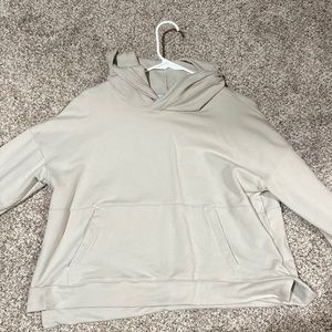 A medium , cropped , beige workout crewneck! It’s super comfy and warm!